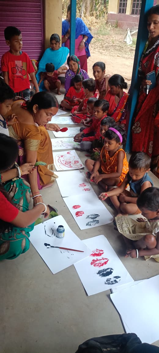 Child holding artwork from an AET art camp